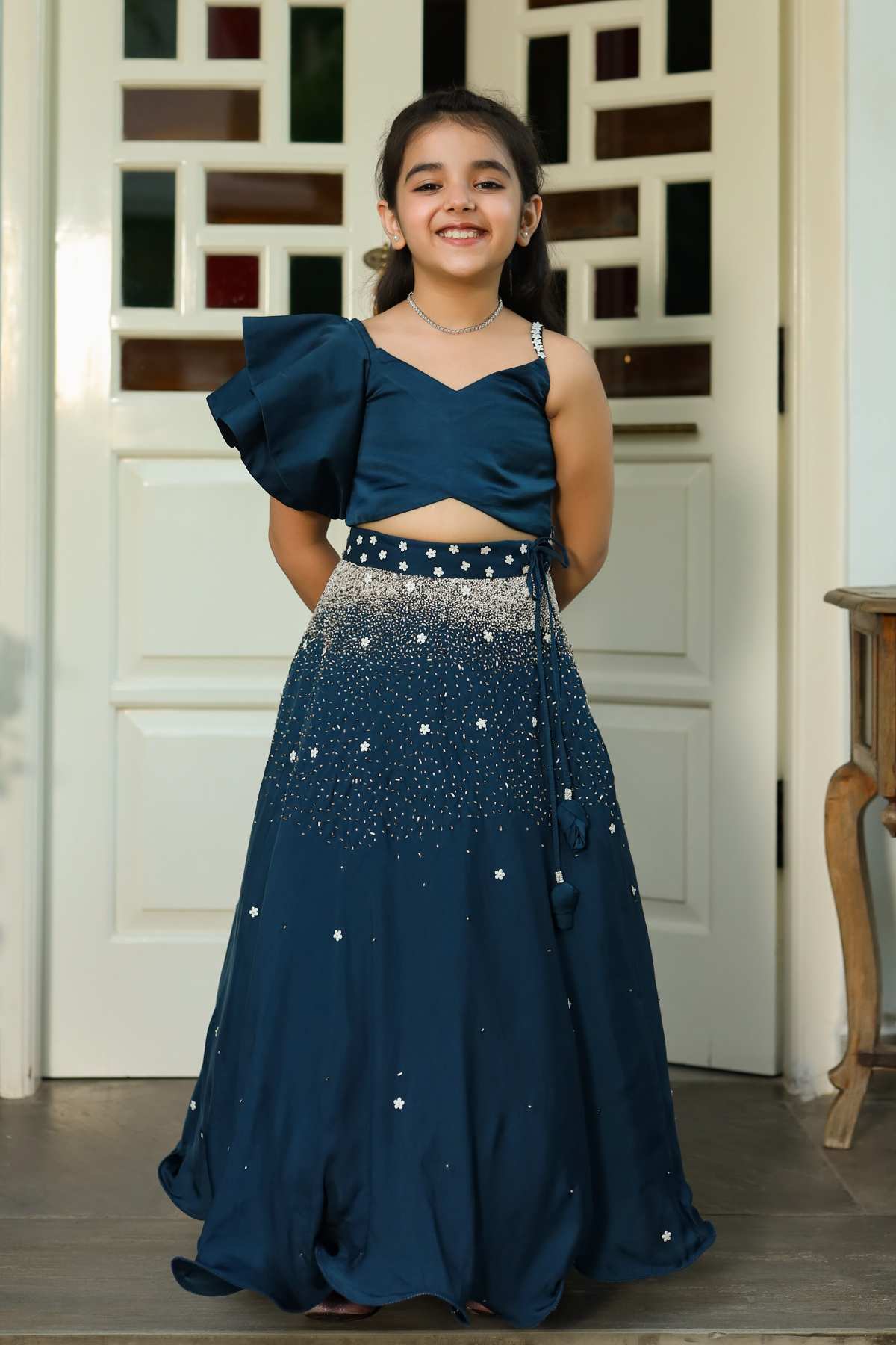 Buy Kids Designer Littleens ruffled shoulder top paired with embroidered skirt extending from the waist to the bottom Online at ScrollnShops